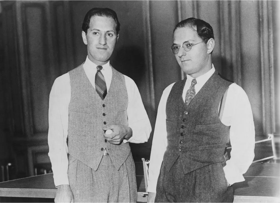 Brothers George (left) and Ira Gershwin take a break from playing table tennis, circa 1925